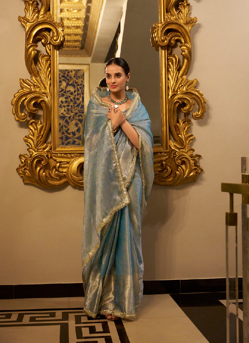 Party wear Sky Blue Tissue shimmer saree with zari weaving and sequin lace.