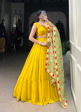 Haldi ceremony ruffle georgette lehenga choli paired with floral organza dupatta.